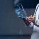 a futuristic image of a futuristic tablet and a healthcare worker using it