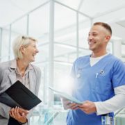 an image of a group of healthcare leaders talking with big smiles on their face