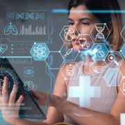 A woman using a digital tablet with a futuristic holographic overlay of medical icons, data charts, and healthcare analytics.